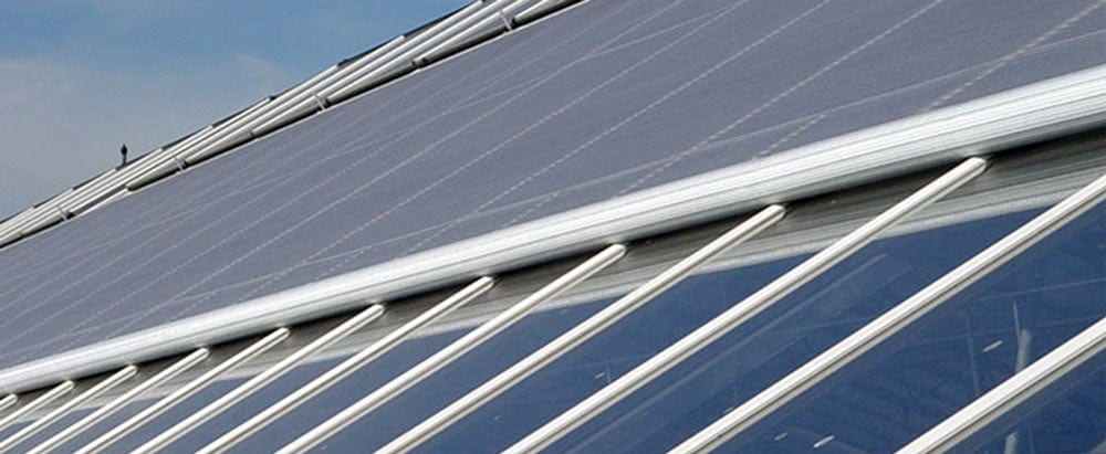 Energy curtains installed in a large greenhouse, filtering sunlight